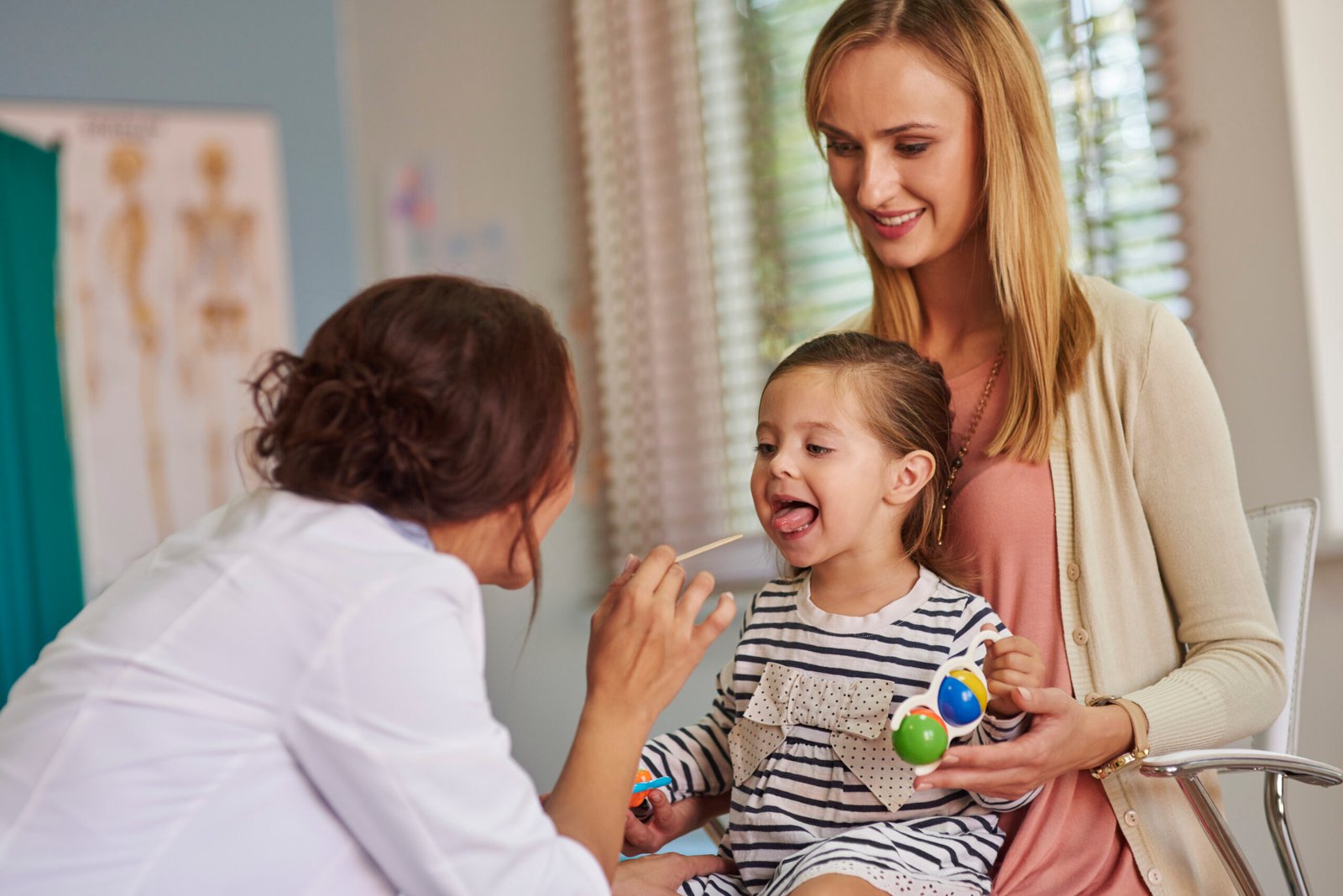 Routine examination of little girl's throat